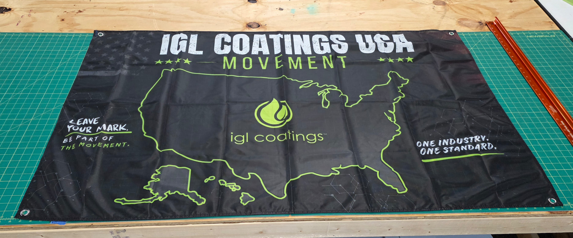 IGL Coatings USA Movement banner laid out on the cutting table in the Saraland shop